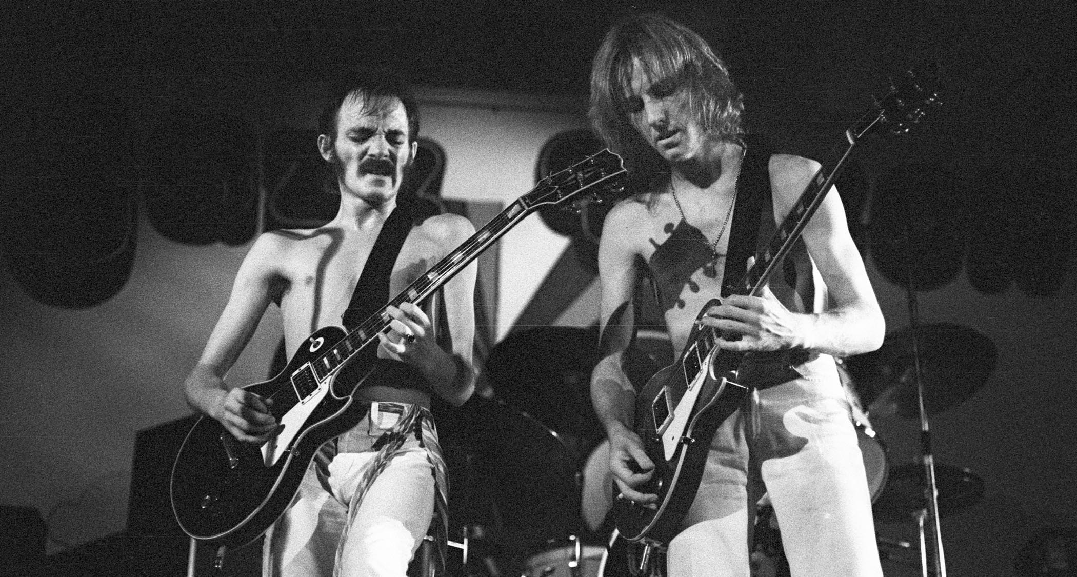 A black-and-white live shot of Steve Marriott [left] and Clem Clempson performing with Humble Pie in 1974