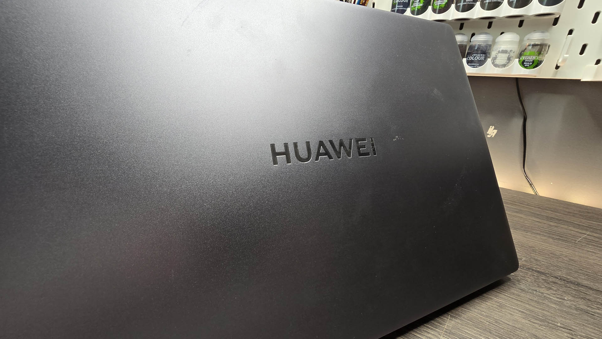 The Huawei MateBook D 16 on a wooden desk.