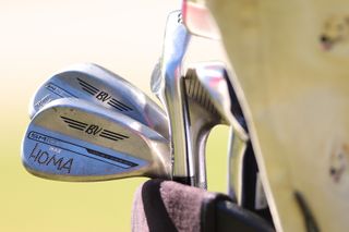 A close up of Max Homa's Vokey SM10 wedges with HOMA printed on them