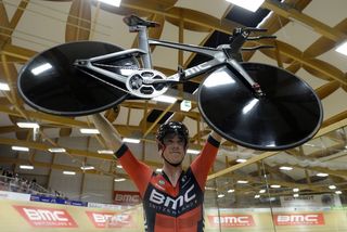 Rohan Dennis holds aloft his BMC after setting the new hour record
