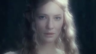 Cate Blanchett stands glowing in a dim setting in The Lord of the Rings The Fellowship of the Ring.