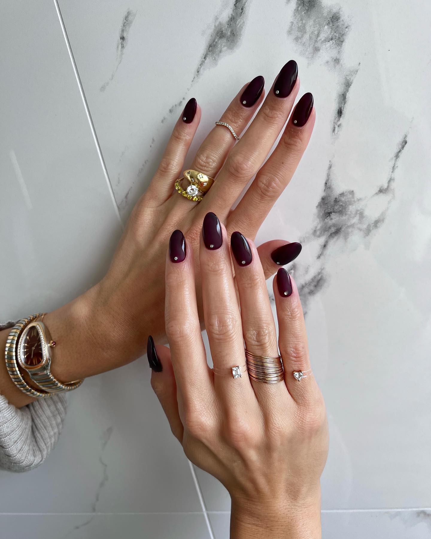 Burgundy manicure with nail gems