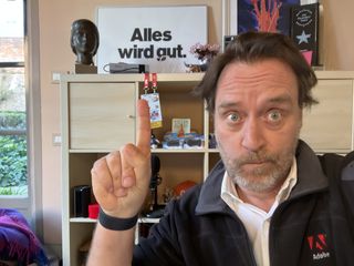 Man pointing to sign in German that says Alles wird gut