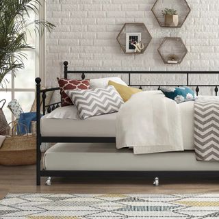 Trundle bed as guest room option, styled with chevron scatter pillows and neutral bedding.