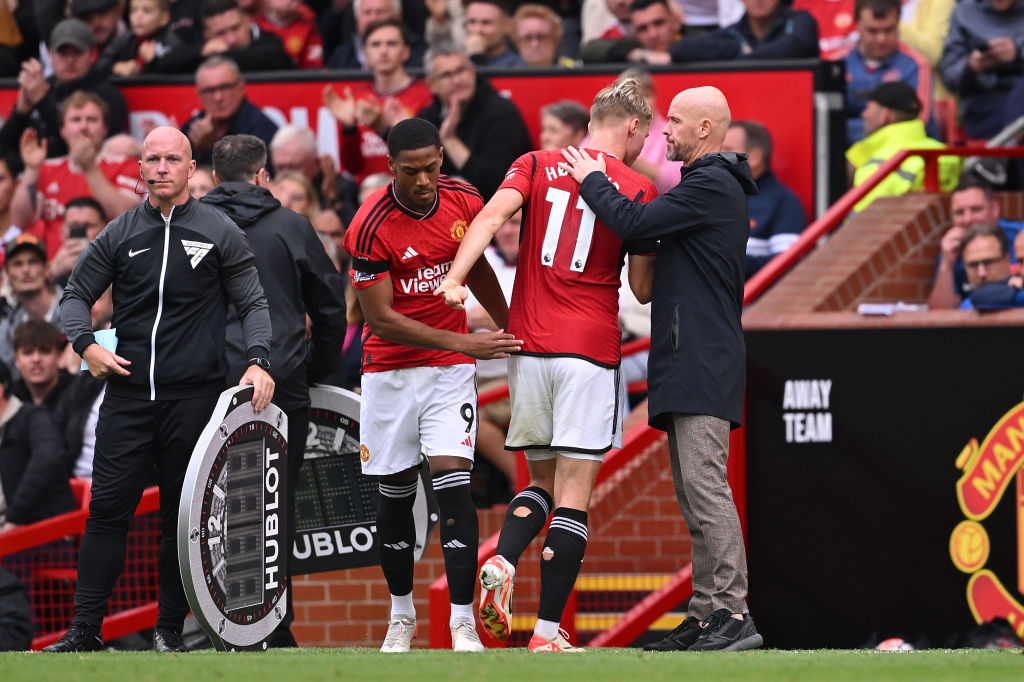 Erik ten Hag, Manager of Manchester United, interacts with Rasmus Hojlund of Manchester United during the Premier League match between Manchester United and Brighton & Hove Albion at Old Trafford on September 16, 2023 in Manchester, England.