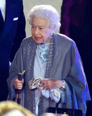 the Queen pictured out with her walking stick