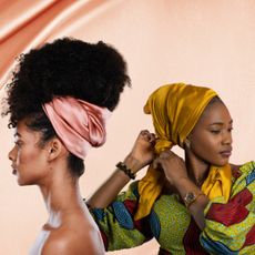 two women wearing silk hair wraps on a pink background