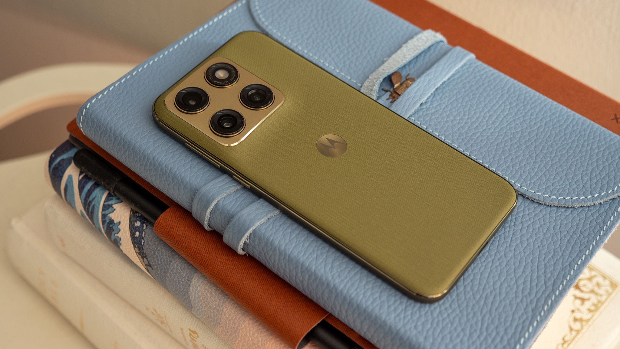 The back of the olive green Motorola Edge 2026 with its metal camera island