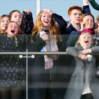 Mia and Lena Tindall cheering along a barrier with Savannah Phillips