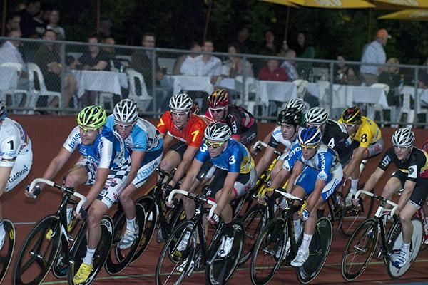 Riders head around the track watched on by dining fans.