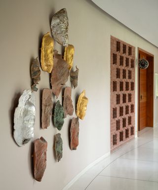 Textured wall art with galvanized detail in minimal hallway styled by Shalini Misra