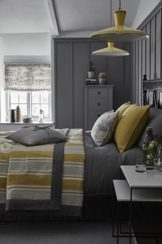 Blinds in bedroom with bed in grey, by Vanessa Arbuthnott