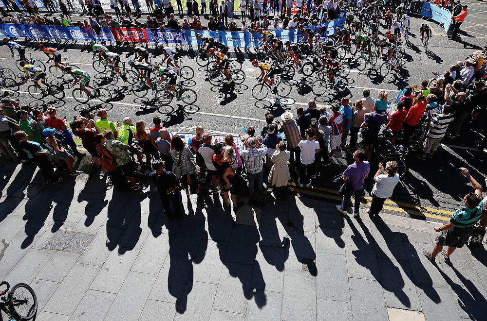 Supporters watch as the peloton passes during stage one of the Tour of Britain in Liverpool City Centre.