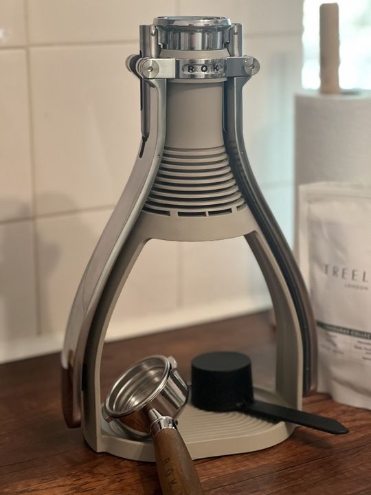 a light gray ROK machine on a wooden kitchen countertop