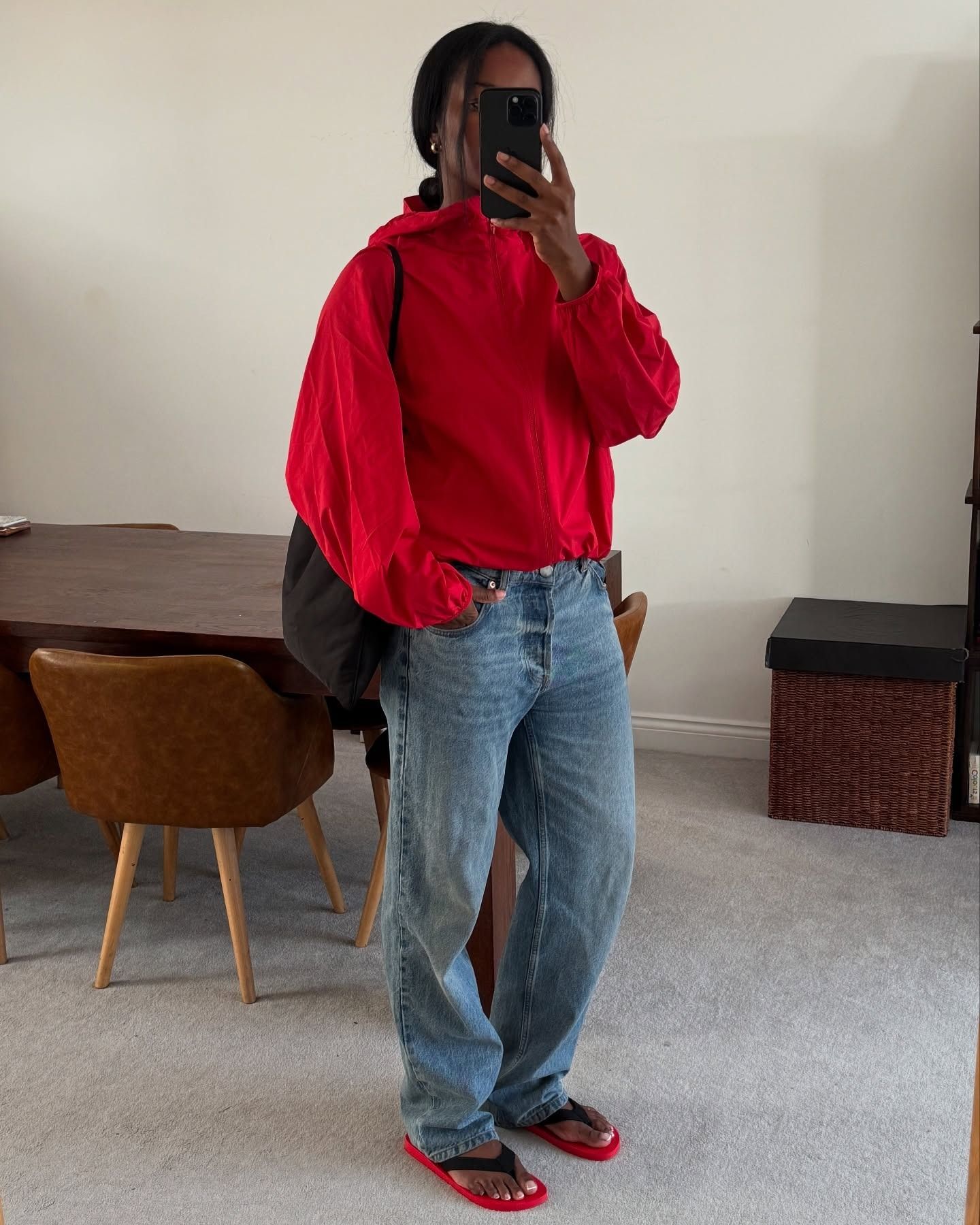 A woman wearing a red sporty jacket.