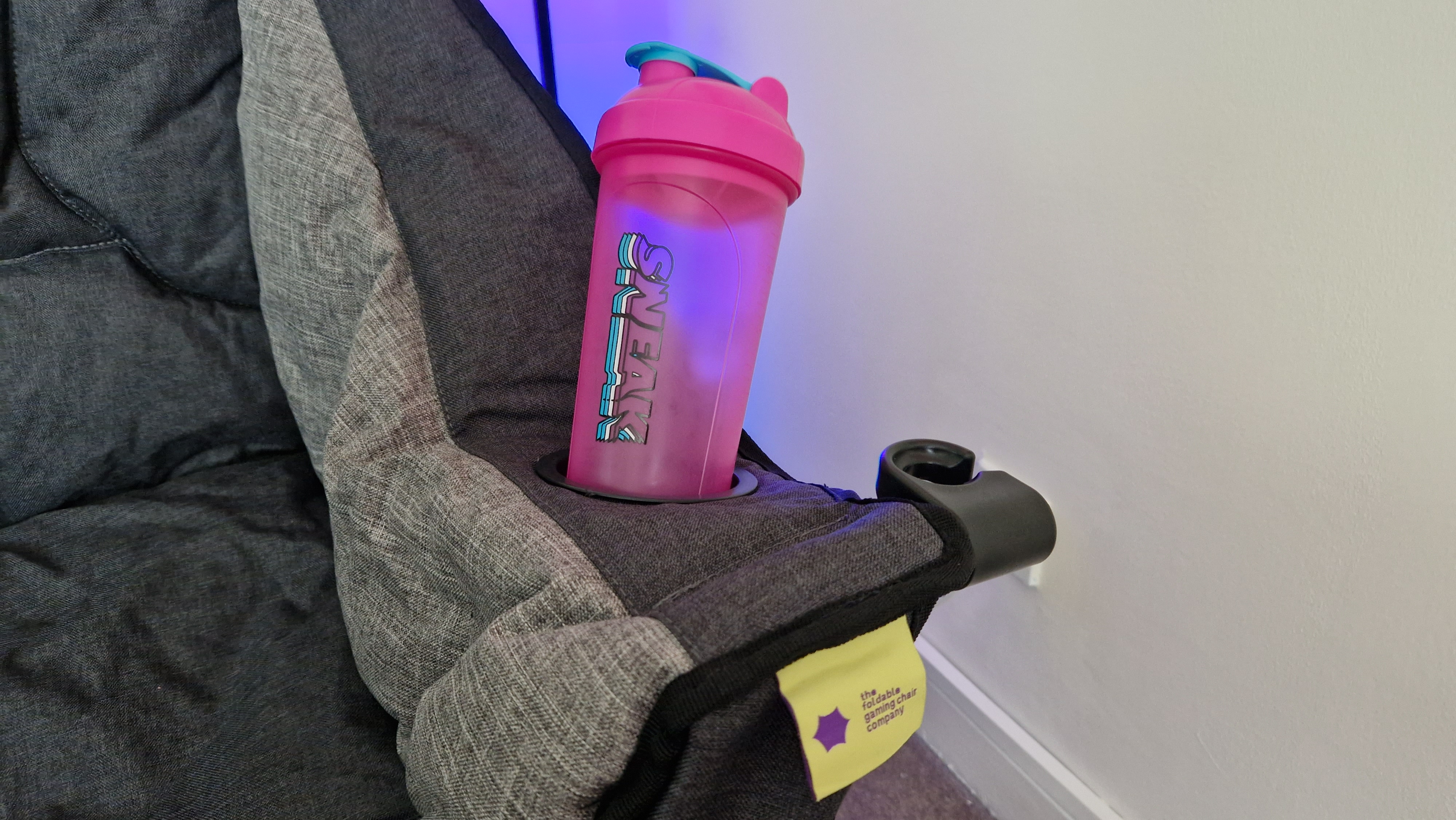 The Foldable Gaming Chair's cupholder, holding a Sneak Energy drink shaker
