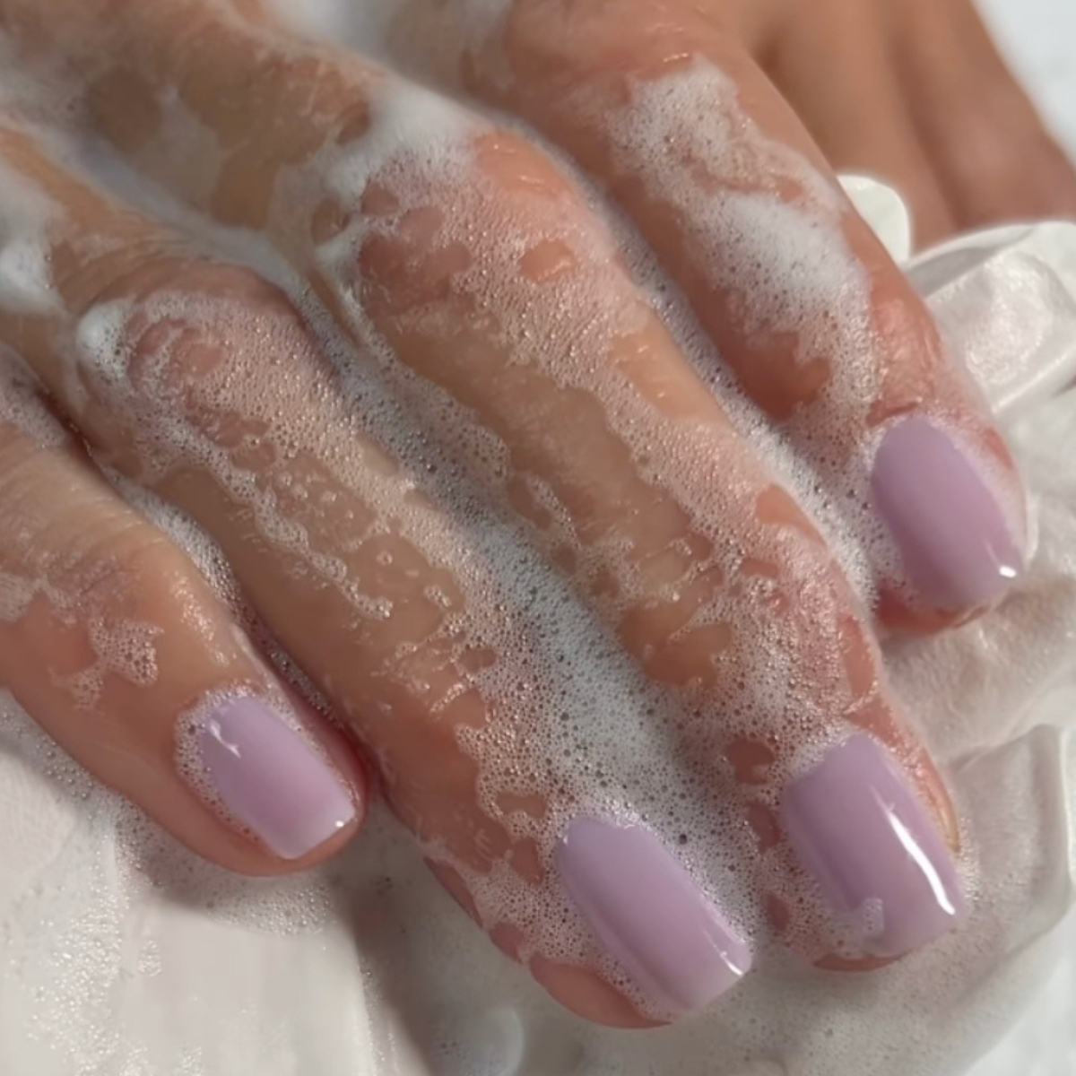 a close up shot of mauve milk nails