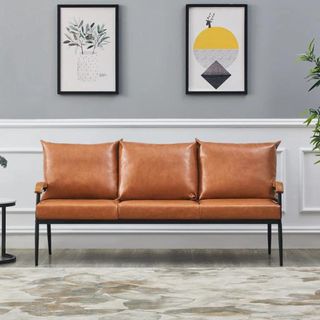 A thin vegan leather sofa with metal legs