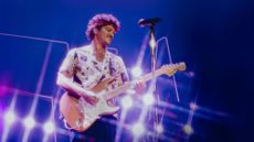 Bruno Mars plays the guitar on stage