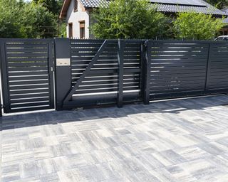 block paved area in garden with gate and fence