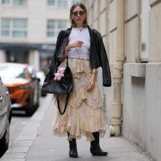 a street style influencer wearing a tiered maxi skirt