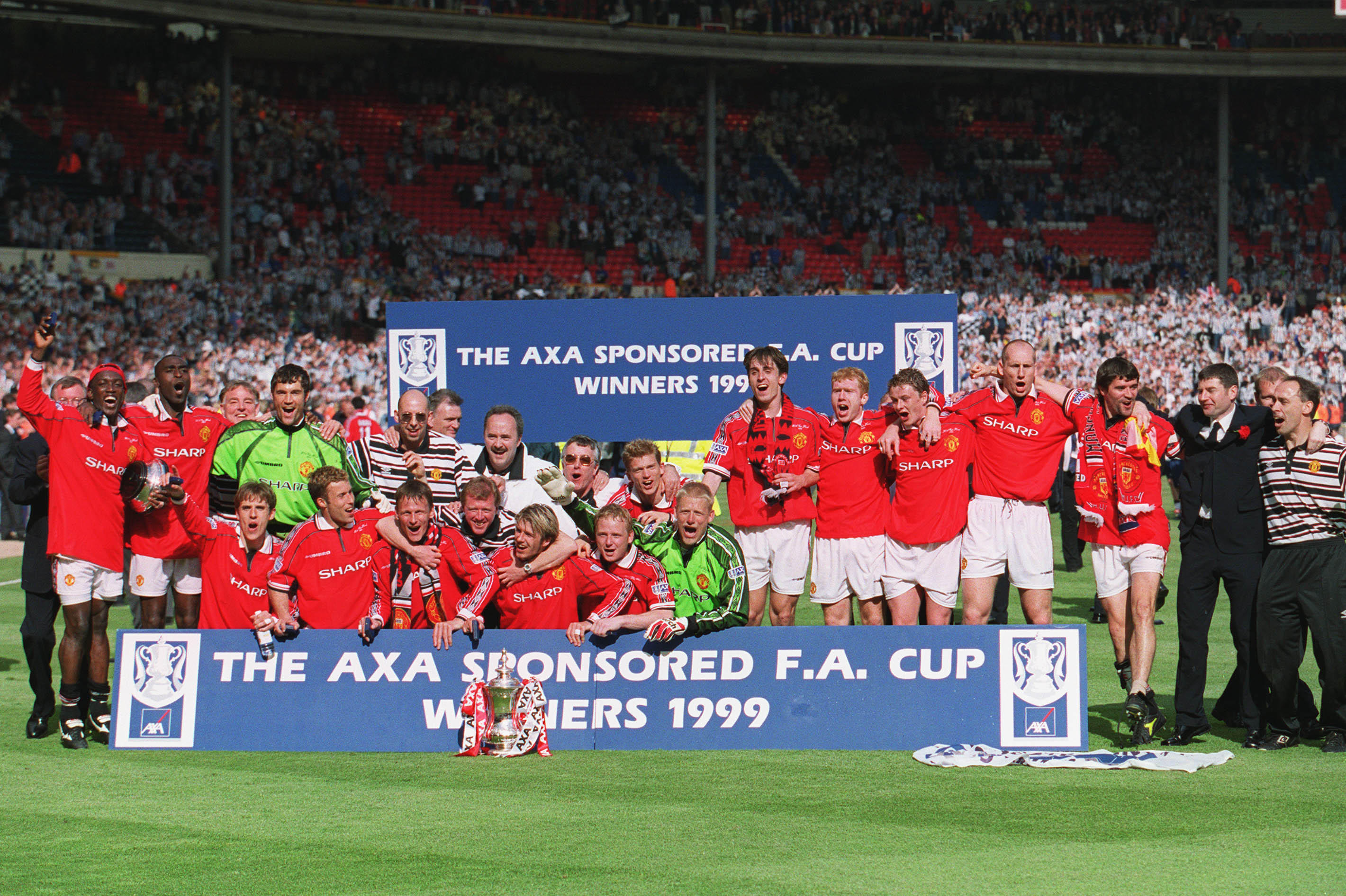 Manchester United celebrate with the trophy after winning the 1999 FA Cup final against Newcastle at Wembley