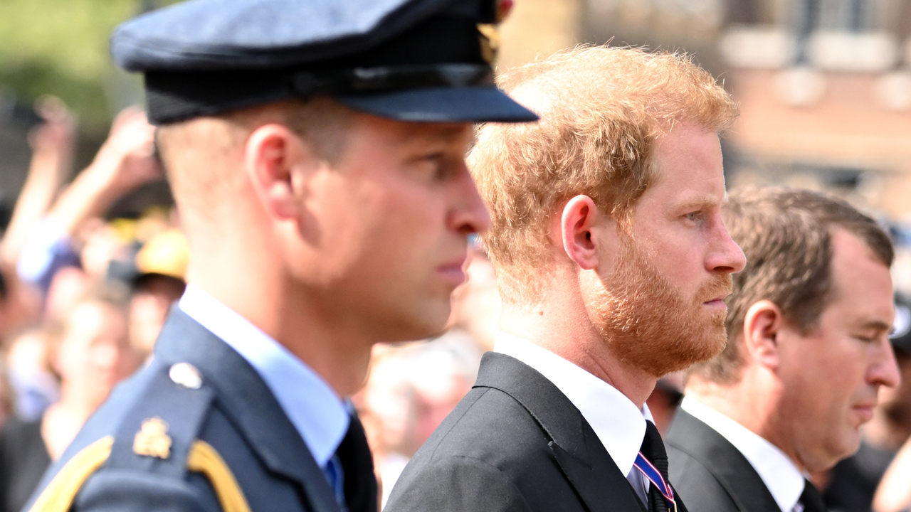 Prince William, Prince of Wales and Prince Harry, Duke of Sussex walk behind the coffin during the procession for the Lying-in State of Queen Elizabeth II on September 14, 2022 in London, England.