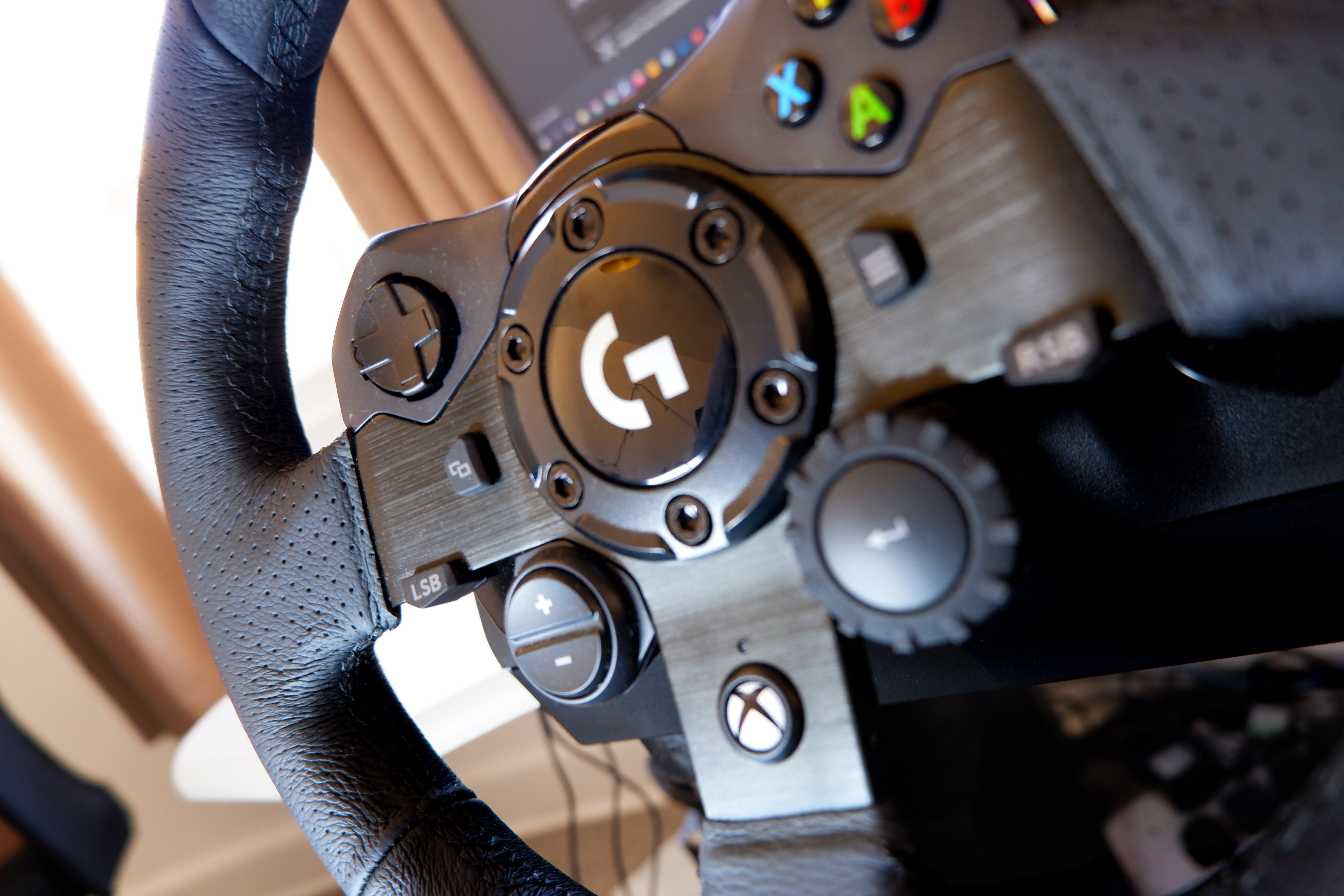 Logitech G923 racing wheel and pedals from various angles at a desk