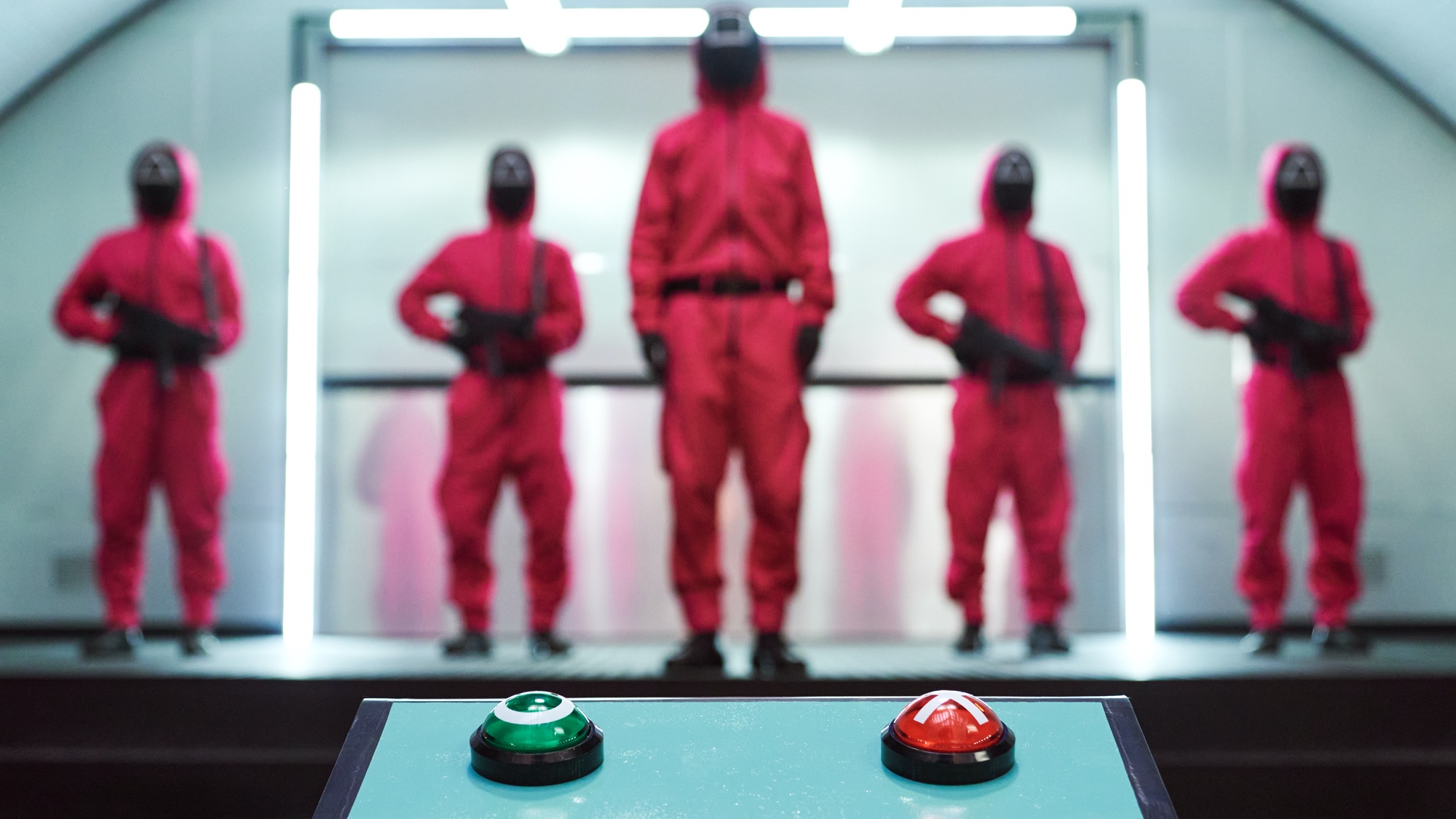 Squid Game's guards in front of a green Circle button and a red X button