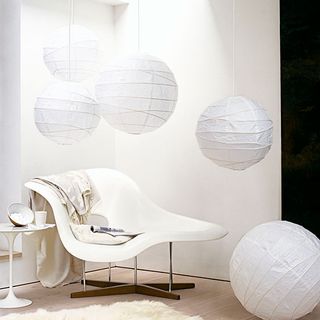 lounge area with white wall and white chaise
