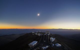A total solar eclipse darkens the sky above the La Silla Observatory in Chile in this aerial shot captured via drone during totality. Thousands of spectators had gathered at the observatory to see the eclipse. In the foreground are several of the telescopes that belong to the observatory, while the Andes Mountains provide a breathtaking backdrop.