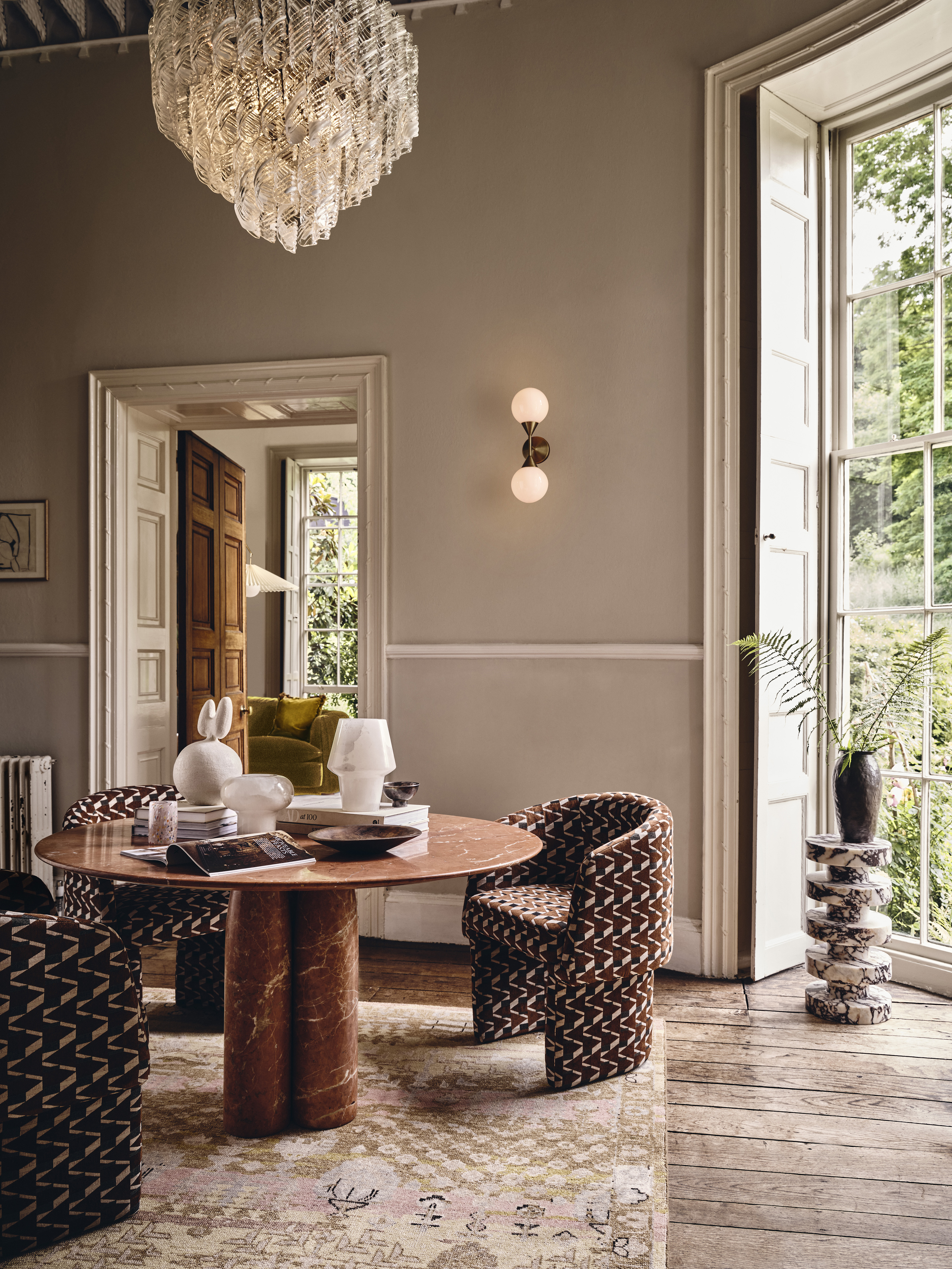 A dining room with light fixtures in warm light