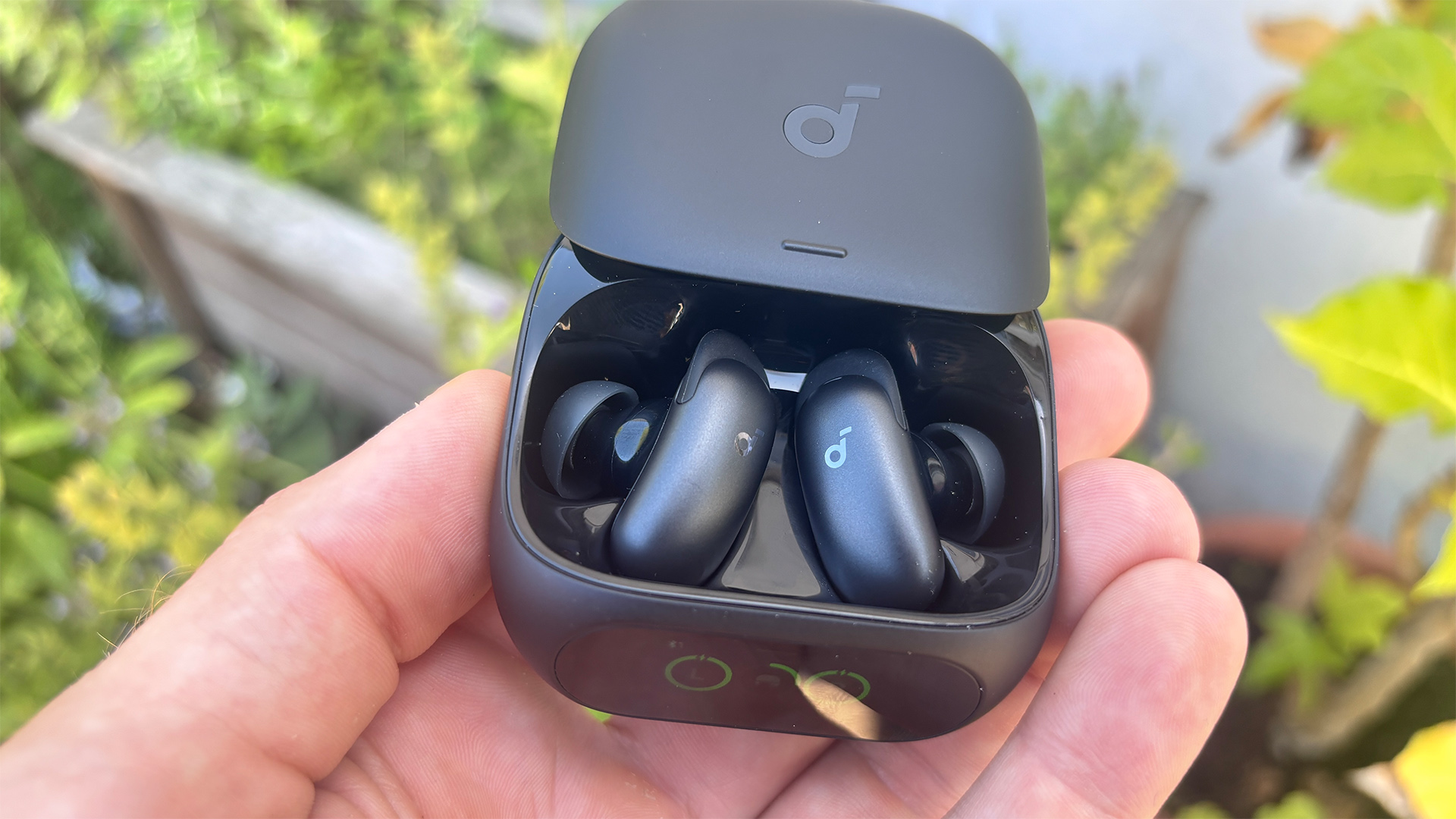 Soundcore Liberty 5 Pro in-ear headphones in open case held in hand