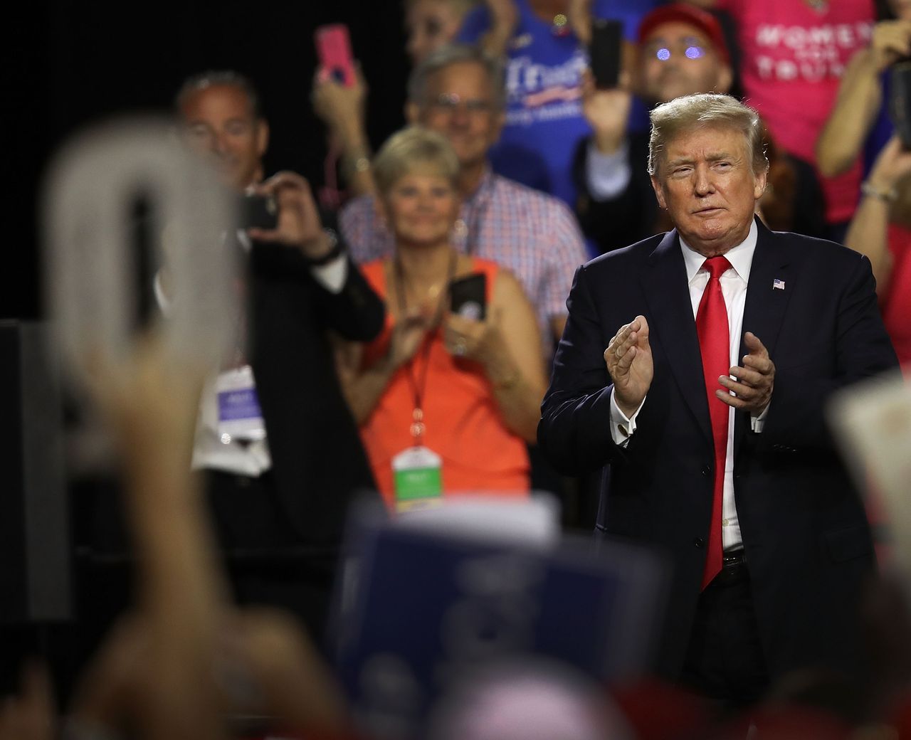 TAMPA, FL - JULY 31:A sign in the shape of a Q is held up as President Donald Trump attends his Make America Great Again Rally being held in the Florida State Fair Grounds Expo Hall on July 3