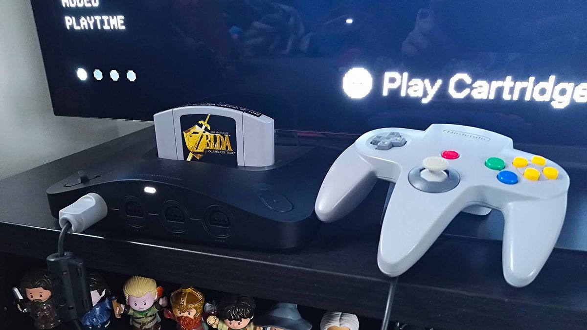 Analogue 3D with Zelda: Ocarina of Time inserted next to original grey controller.