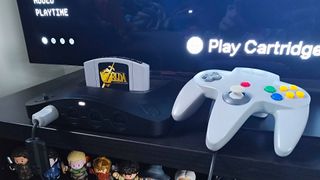 Analogue 3D with Zelda: Ocarina of Time inserted next to original grey controller.