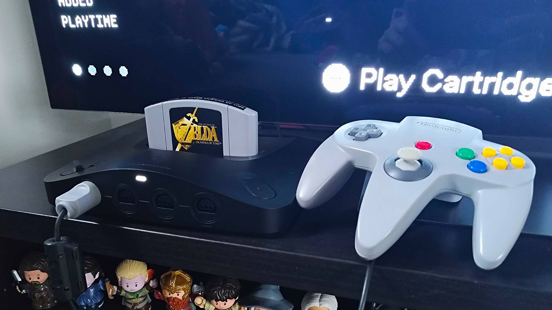 Analogue 3D with Zelda: Ocarina of Time inserted next to original grey controller.