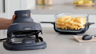 Ninja Crispi 4-in-1 Portable Glass Air Fryer making chips