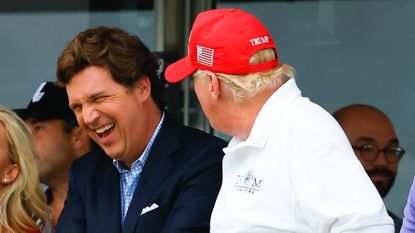 Carlson laughing with Trump at Trump National Golf Club in July 2022