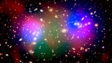 A galaxy cluster colorized to show invisible dark matter (blue) alongside regular, visible matter (red, green, and orange).