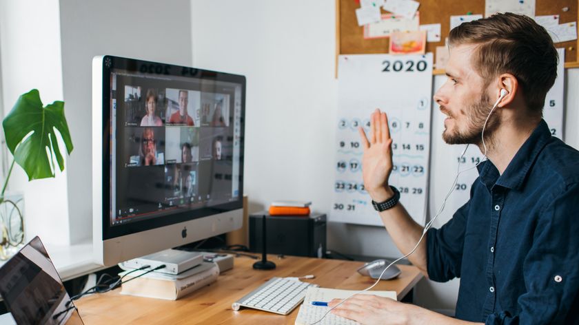 A man video conferencing using an iMac computer.