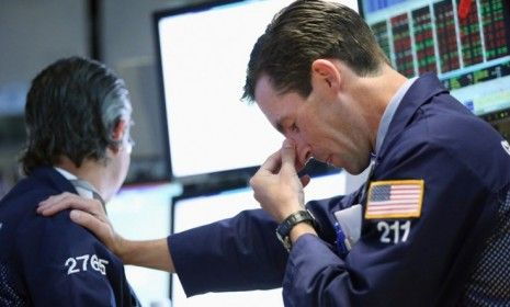 Traders work on the floor of the New York Stock Exchange