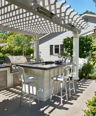 Rustic outdoor kitchen with a board and batten base