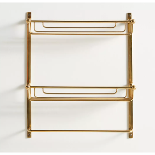 gold two-tier shelf with towel rack at the base