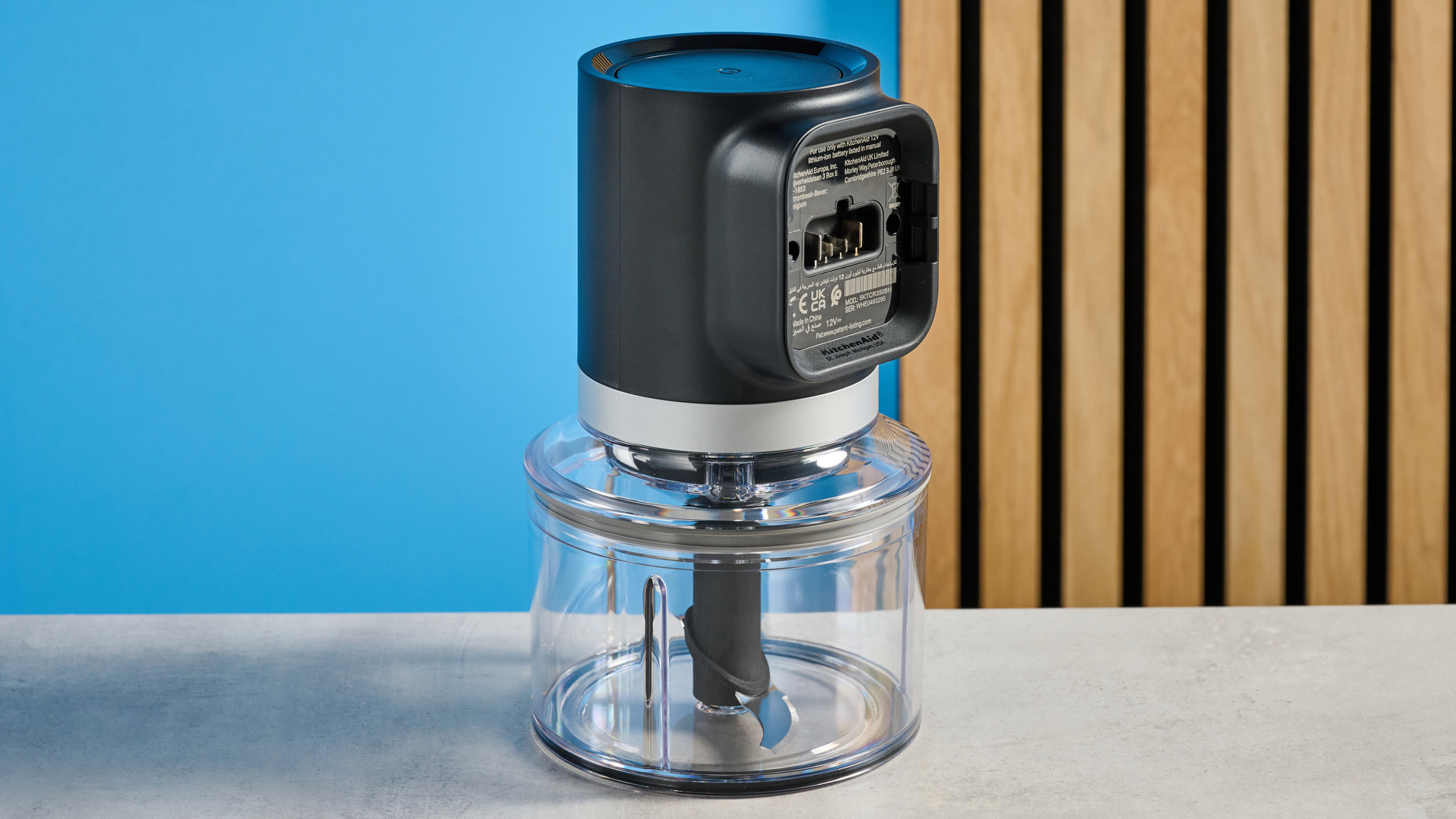 KitchenAid Cordless Top Down Food Chopper photographed in front of a blue background.