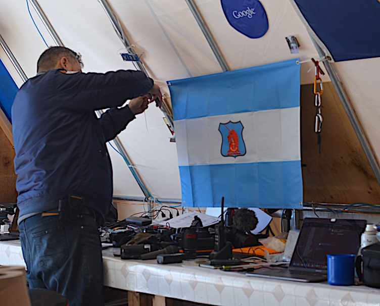 Pascal mounts the Shackleton flag in the ops center at the Haughton-Mars Project base.