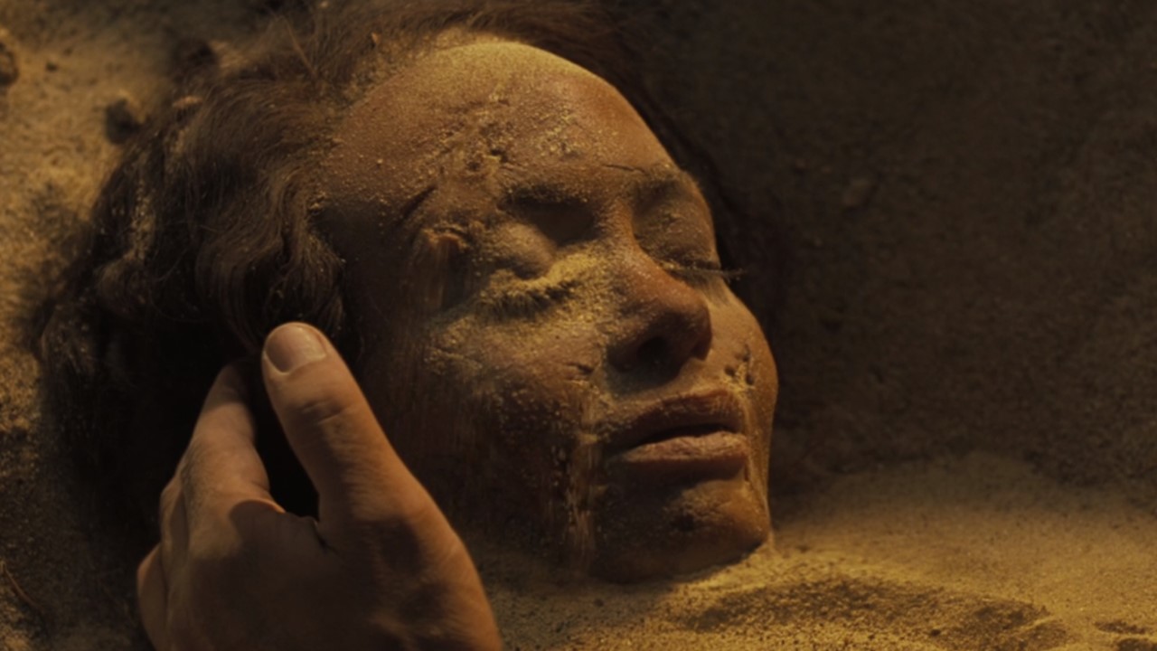 Maeve buried in the sand at Westworld