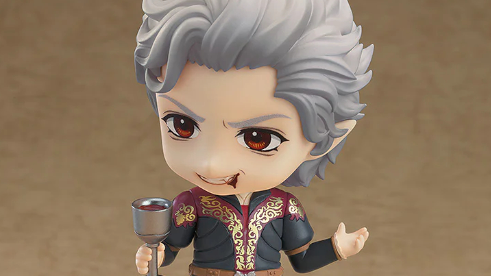 A Nendoroid Astarion figure holds a goblet of wine, or blood, while smiling