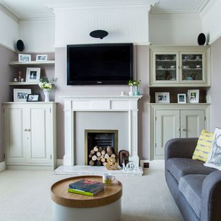 Neutral living room with fireplace surrounded by open and closed storage