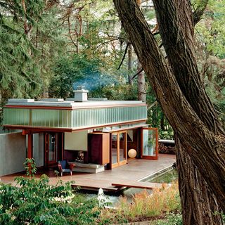 wooden house with chimney in forest